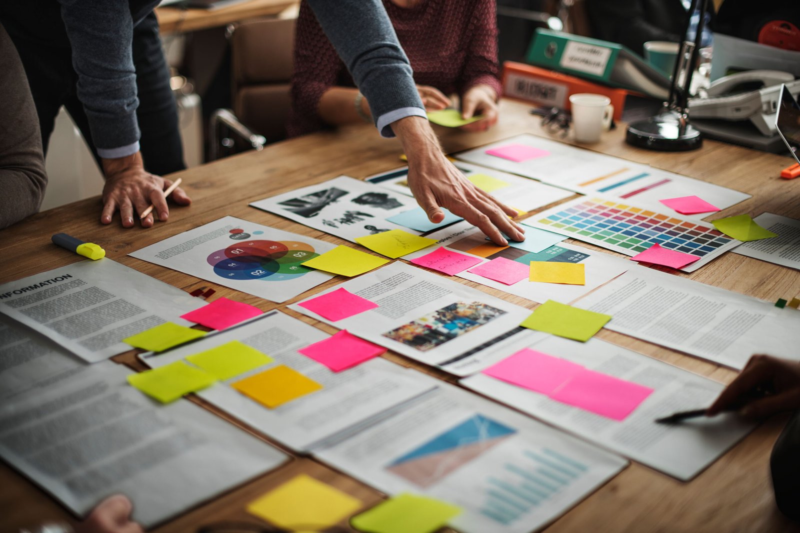 Marketing team reviewing color swatches and sticky notes during a brand strategy session